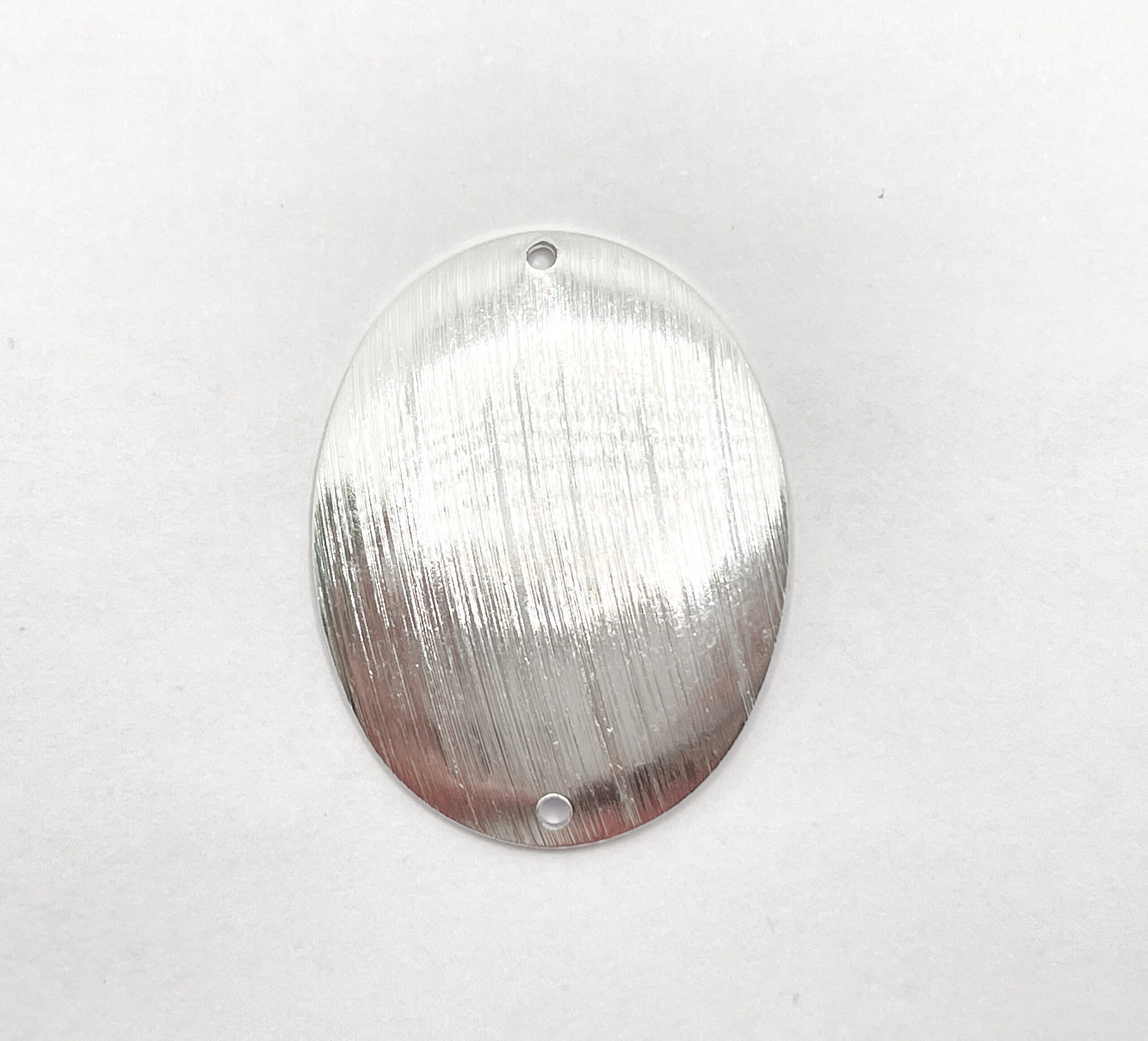 Chapa Plateada Ovalada 25mm